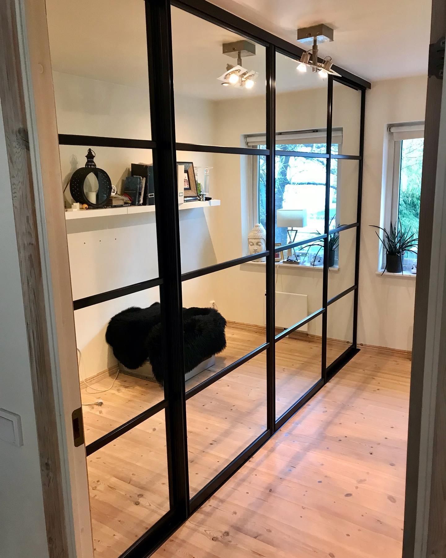 Black-framed glass in a room with a wood floor