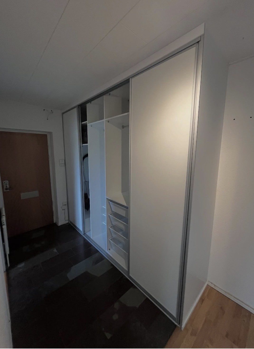 Open wardrobe with shelves in a hallway