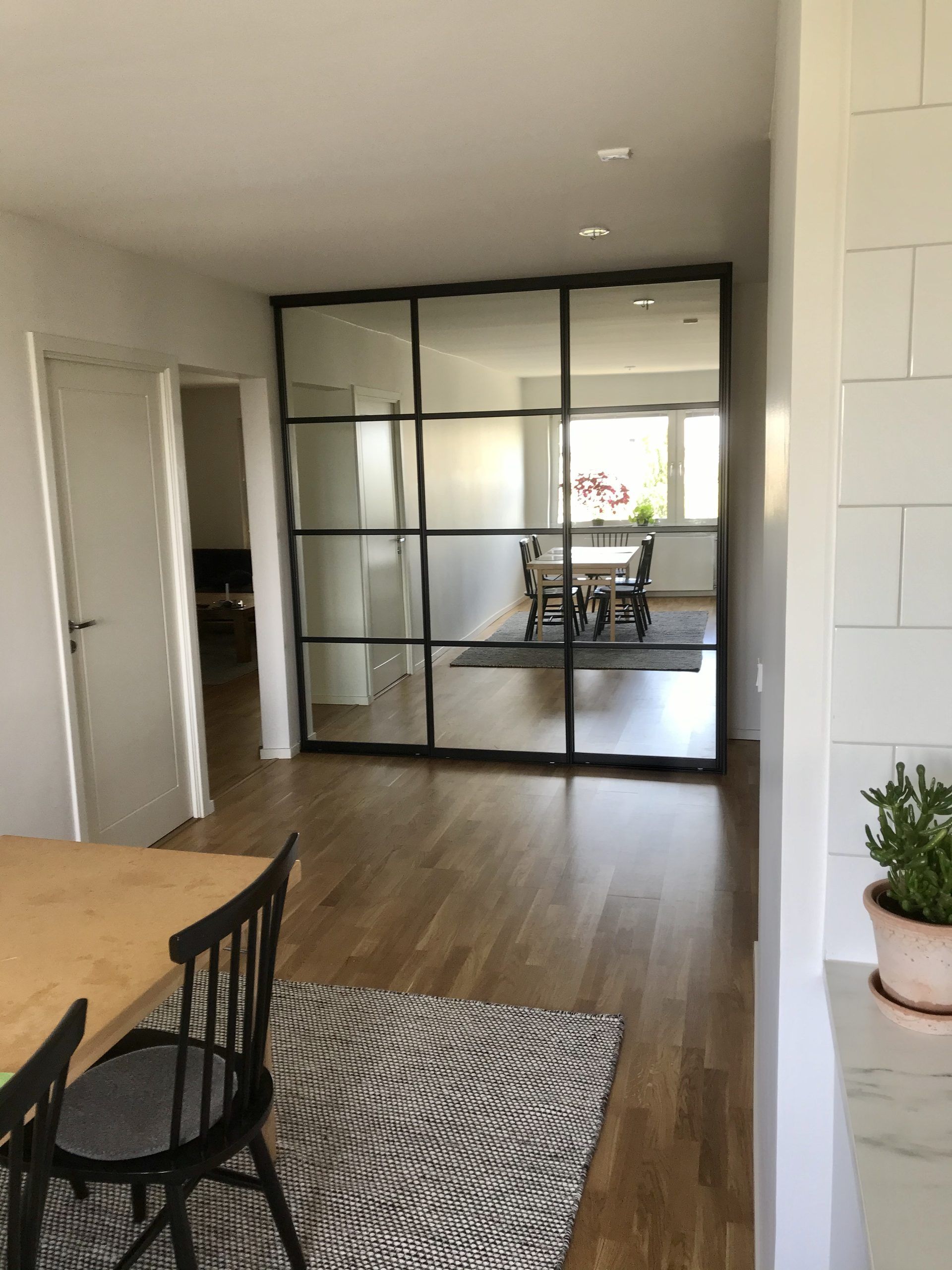Black-framed glass between hall and dining area