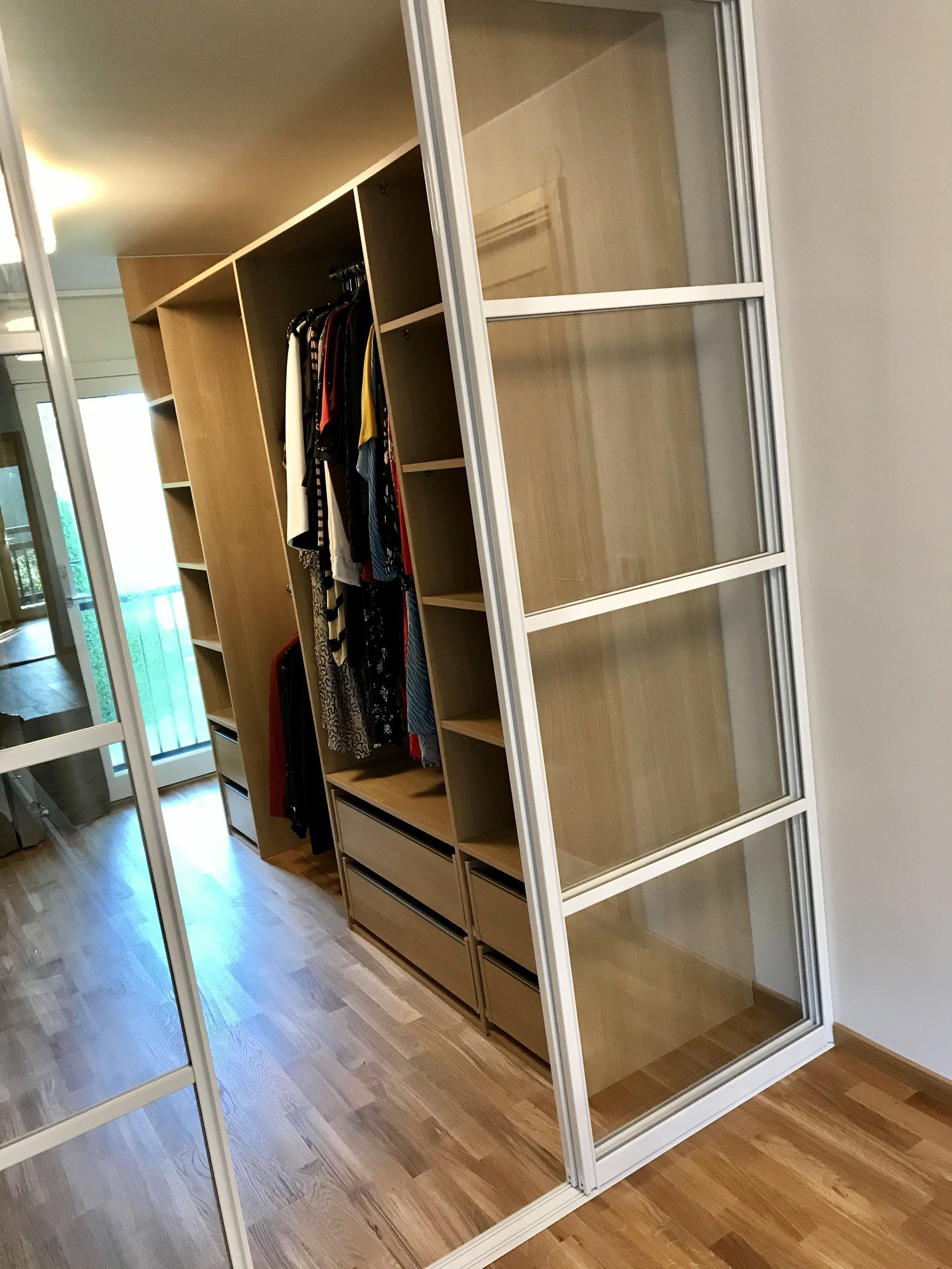 Oak shelving and rail in a bright walk-in