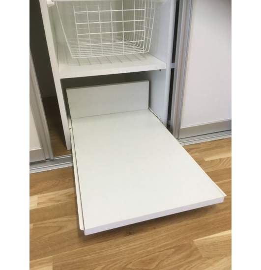 White pull-out shelf for shoes extended from a wardrobe, with wire baskets above.