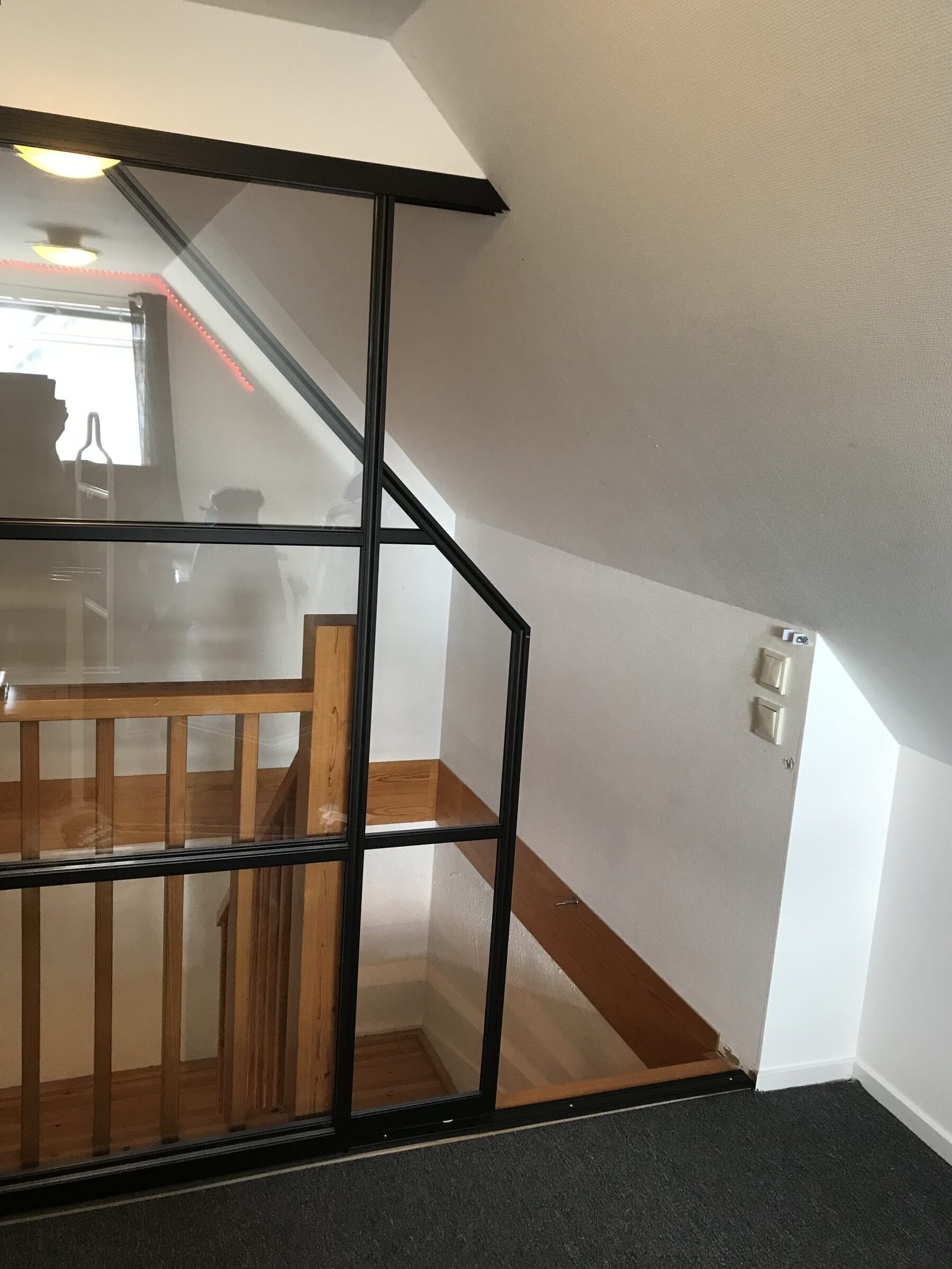 Same stairwell, sloped ceiling behind the frame